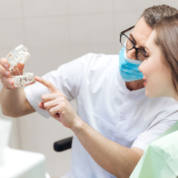 dentist fitting a mouthguard